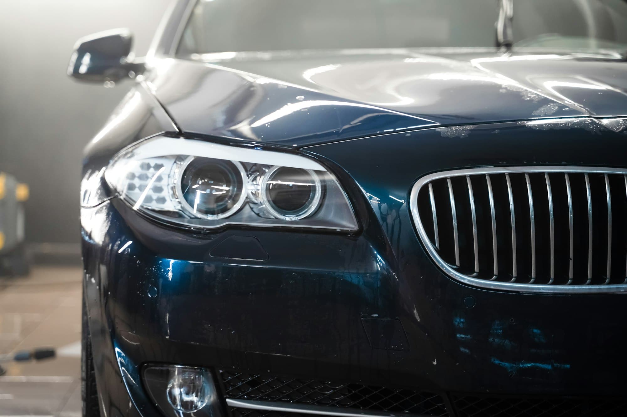 Close-up of a vehicle being pressure washed